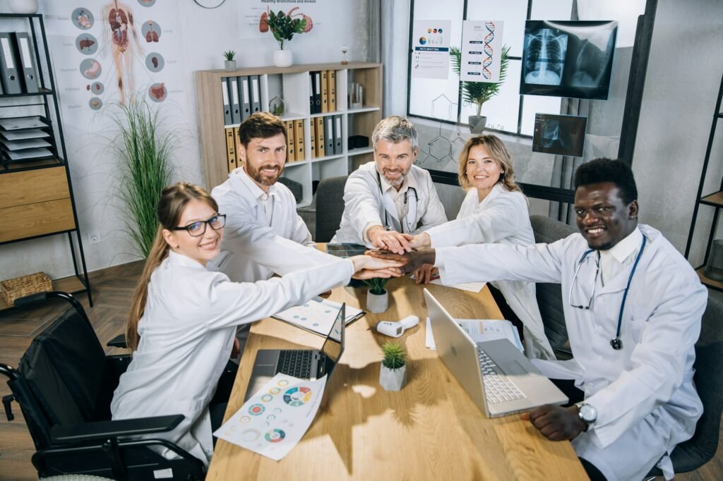 Mixed race doctors stacking hands for successful cooperation